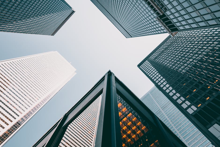 Low angle view of modern skyscrapers with glass facades against a clear sky